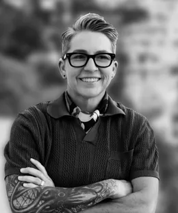 Kara Steffen, founder of The Change Up Group, smiling, arms crossed, outdoors